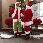 Santa Claus and the Grinch in a festive indoor setting, perfect for Christmas-themed content.